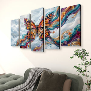 A five-panel canvas wall art set depicting a colorful Monarch butterfly over abstract swirling clouds, displayed above a green sofa in a living room setting.
