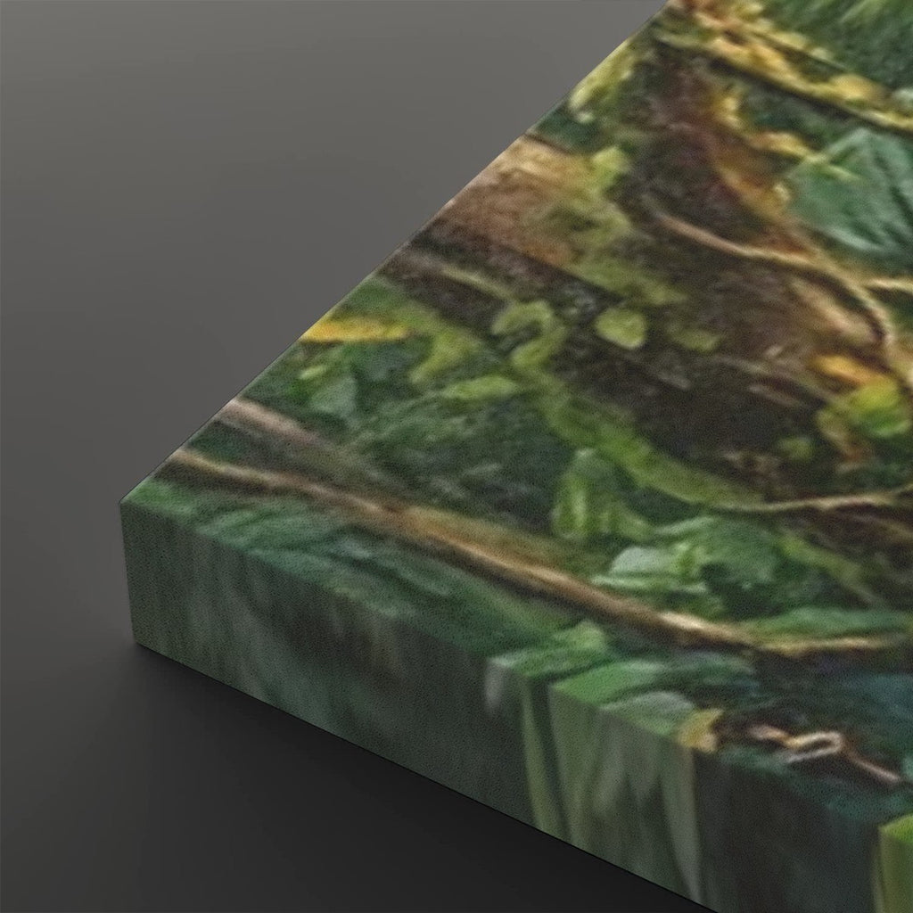 A close-up of a canvas or print showing a textured green and brown forest scene with leaves and branches, photographed at an angle against a dark gray background.