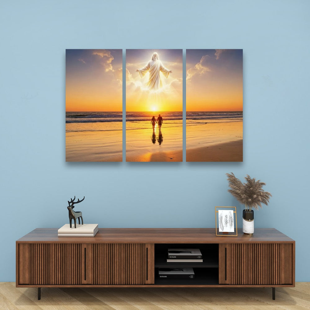 A three-panel canvas wall art set depicting Jesus floating on a beach at sunset, displayed above a wooden console table against a light blue wall.