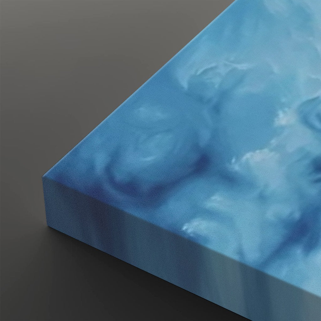 A close-up of a square canvas print showing its three-dimensional edge, featuring an abstract blue and white marbled pattern on a dark gray background.