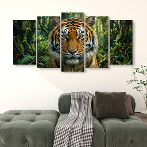 A five-panel canvas wall art set depicting a close-up tiger face in a lush green jungle, displayed above a modern gray sofa in a living room setting.