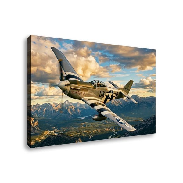 A rectangular canvas wall art print showing a vintage military fighter plane flying over mountains under a dramatic cloudy sky, photographed against a plain white background.