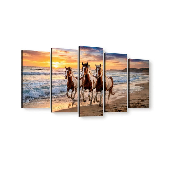 A five-panel canvas wall art set depicting three horses running along a sandy beach at sunset, shown against a plain white background.