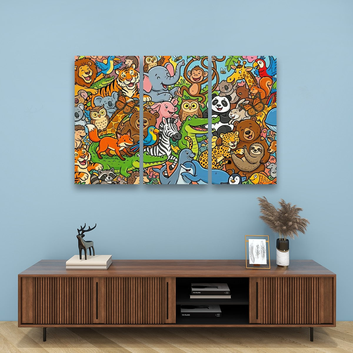 A three-panel canvas wall art print featuring a colorful cartoon jungle scene with various animals, displayed on a light blue wall above a wooden console table.
