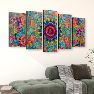 A 5-panel canvas wall art set featuring a vibrant, colorful bohemian mandala design, displayed on a white wall above a green sofa in a living room setting.