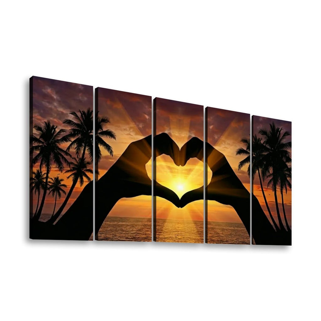 Five-panel canvas wall art showing a tropical sunset with palm tree silhouettes and two hands forming a heart shape over the ocean.