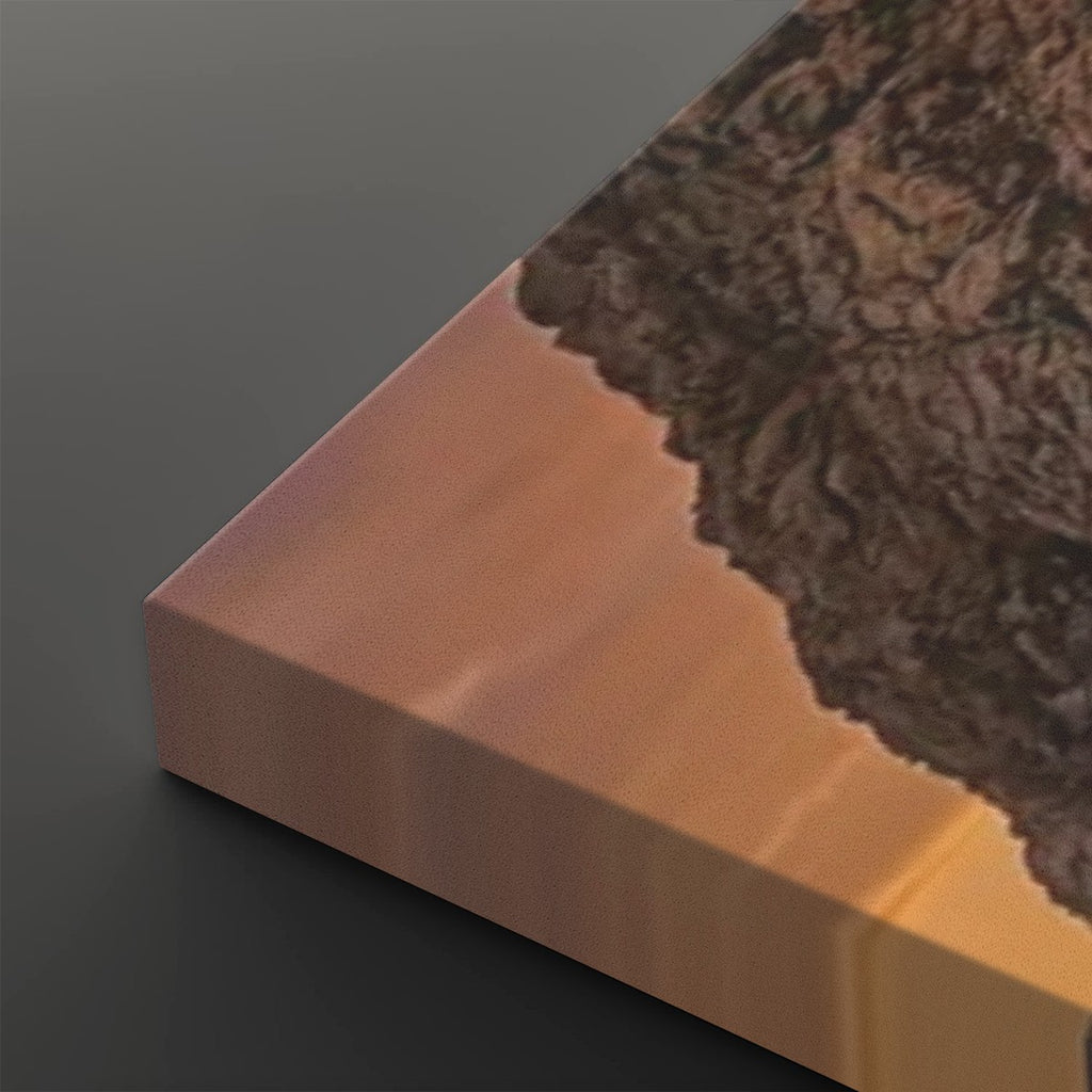 A close-up of a rectangular block or panel with a smooth warm copper-pink face, a dark brown textured top surface, and a dark gray background.