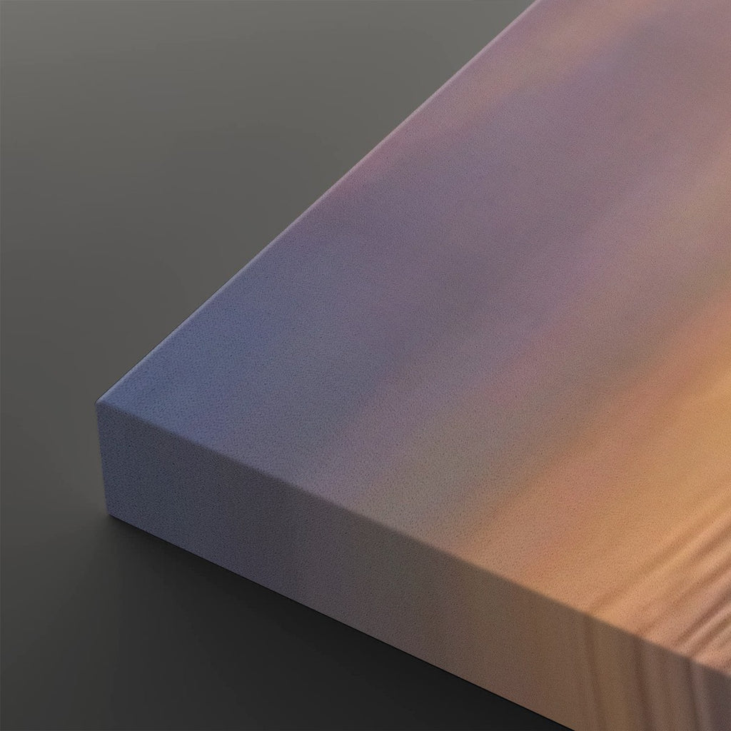 A close-up of a rectangular panel or book-like object showing a smooth iridescent surface that shifts from lavender and blue to warm peach and gold, set against a dark gray background.