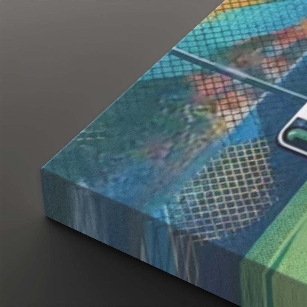 A close-up angled view of a rectangular canvas or print featuring an abstract blue-toned design with grid-like texture and blurred multicolor areas, set against a dark gray background.
