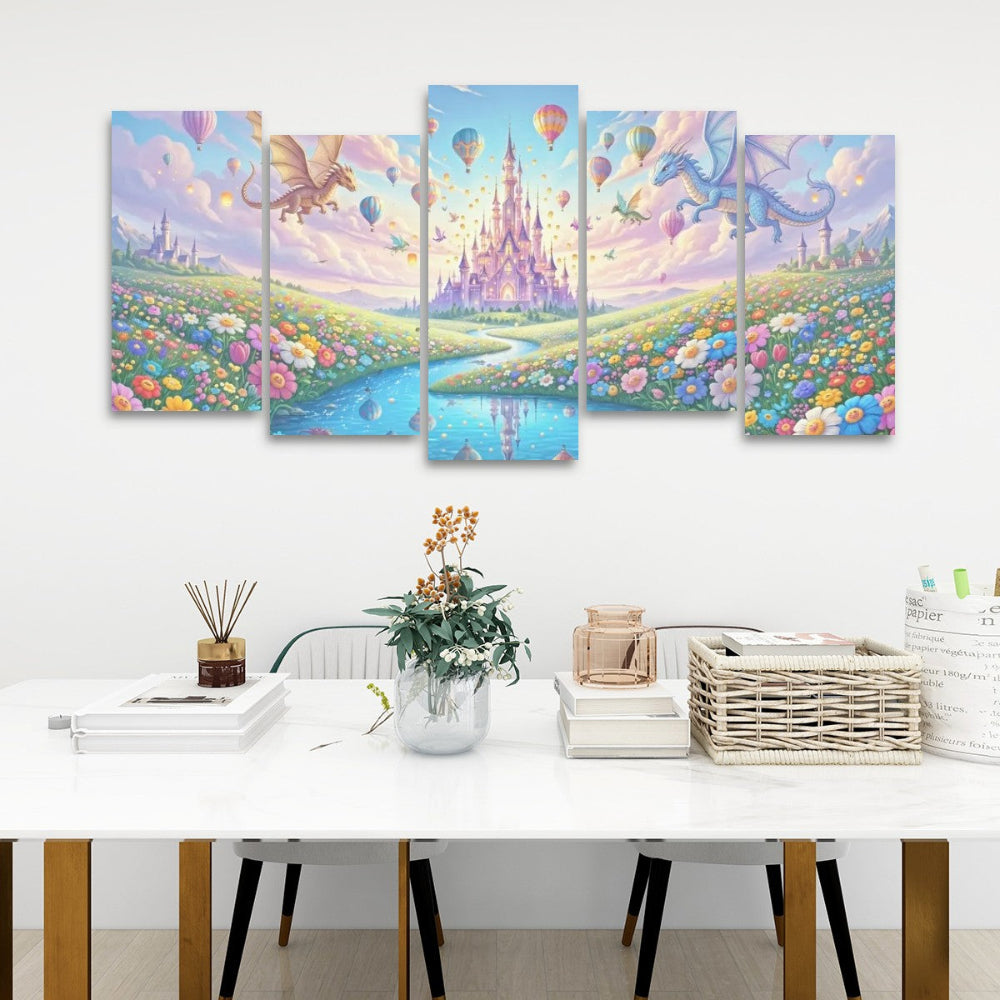 A five-panel canvas wall art set depicting a whimsical fantasy landscape with a pastel castle, hot air balloons, dragons, and a flower field, displayed above a white table in a styled room setting.