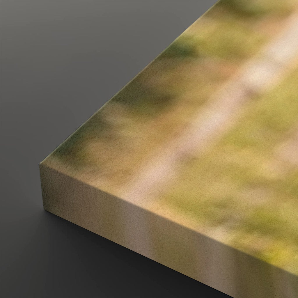 A close-up of a rectangular metallic panel or block with a blurred outdoor scene printed on its top surface, set against a dark gray background.