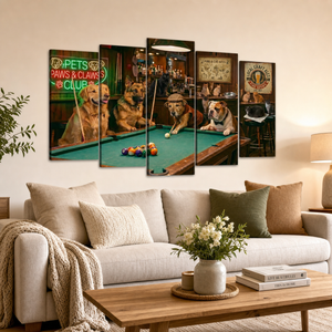 A five-panel canvas wall art set depicting four golden retrievers playing pool in a bar, displayed on a beige wall above a modern light gray sofa in a styled living room.