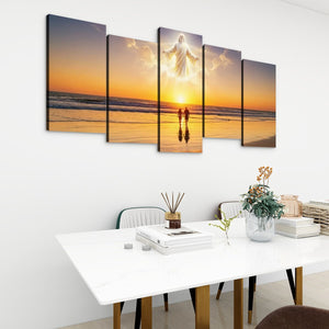 A 5-panel canvas wall art set depicting a religious scene of Jesus on a beach at sunset, displayed on a white wall above a modern white dining table with chairs and decorative items.