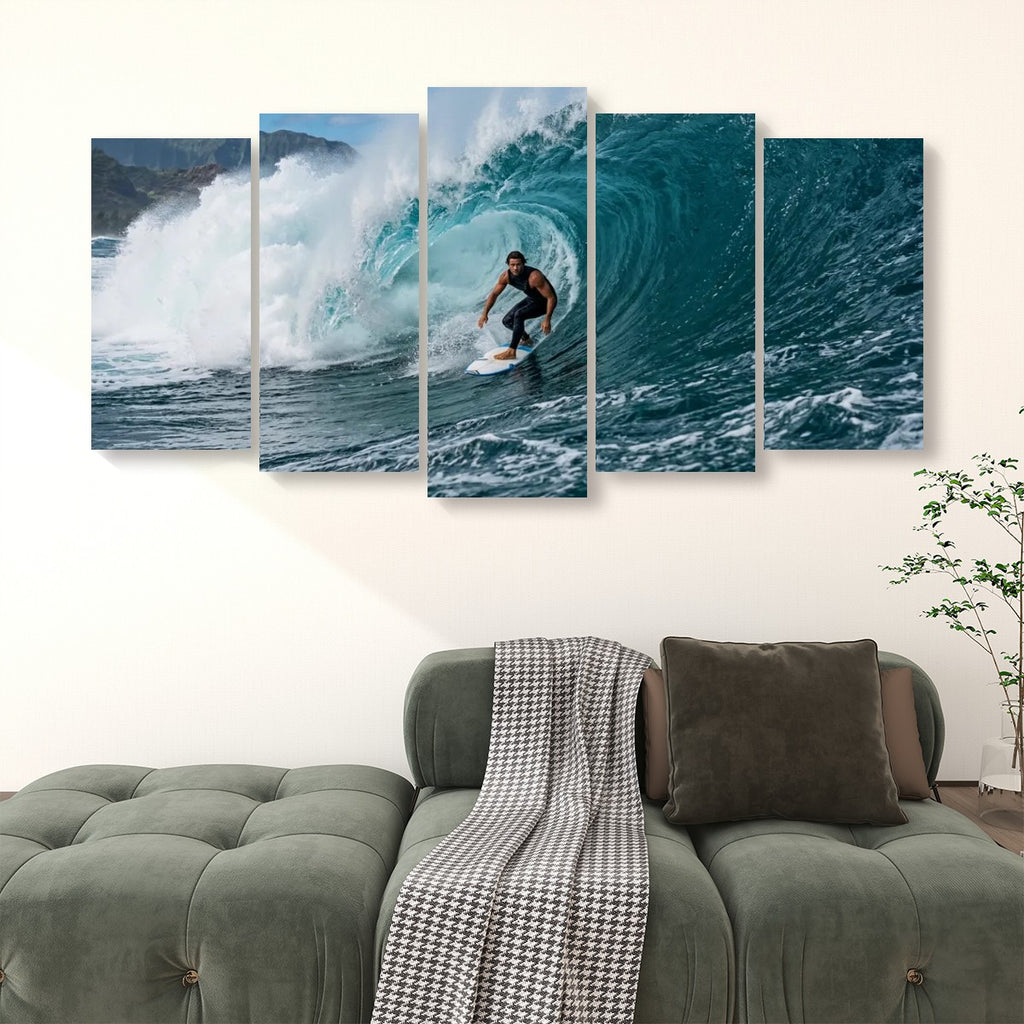 A five-panel canvas wall art set depicting a surfer riding a large blue ocean wave, displayed above a green sofa in a living room setting.