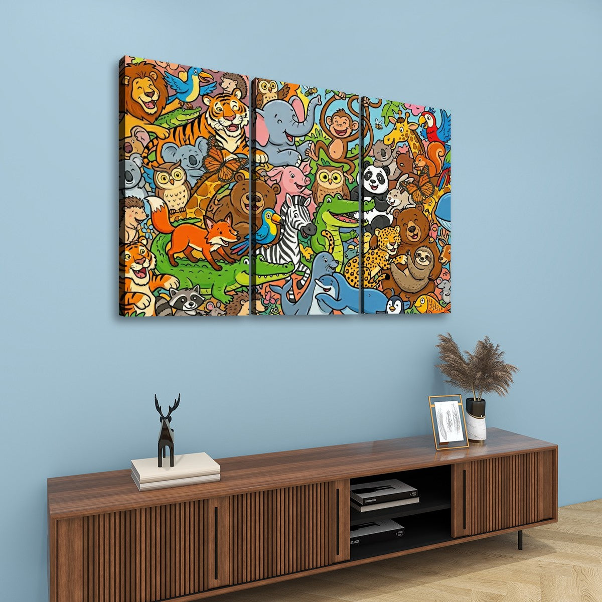 A three-panel canvas wall art print featuring a colorful cartoon jungle scene with many animals, displayed above a wooden console table against a light blue wall.