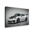 A rectangular wall art print or canvas showing a white Porsche 911 GT3 with a black carbon-fiber hood and rear wing, photographed at an angle against a light gray studio background.