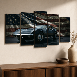 A five-panel canvas wall art set depicting a black 972 Corvette  sports car in front of a distressed American flag, displayed on a beige wall above a wooden console table with a vase and bowl.