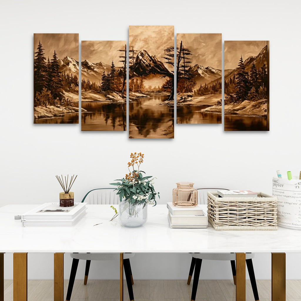 A five-panel canvas wall art set depicting a sepia-toned mountain lake landscape, displayed above a white dining table in a modern room setting.