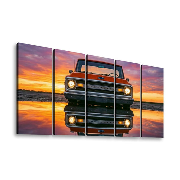 A five-panel canvas wall art set depicting a vintage orange Chevrolet pickup truck facing forward on a reflective surface at sunset, shown against a plain white background.