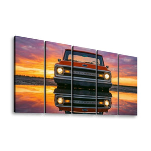 A five-panel canvas wall art set depicting a vintage orange Chevrolet pickup truck facing forward on a reflective surface at sunset, shown against a plain white background.