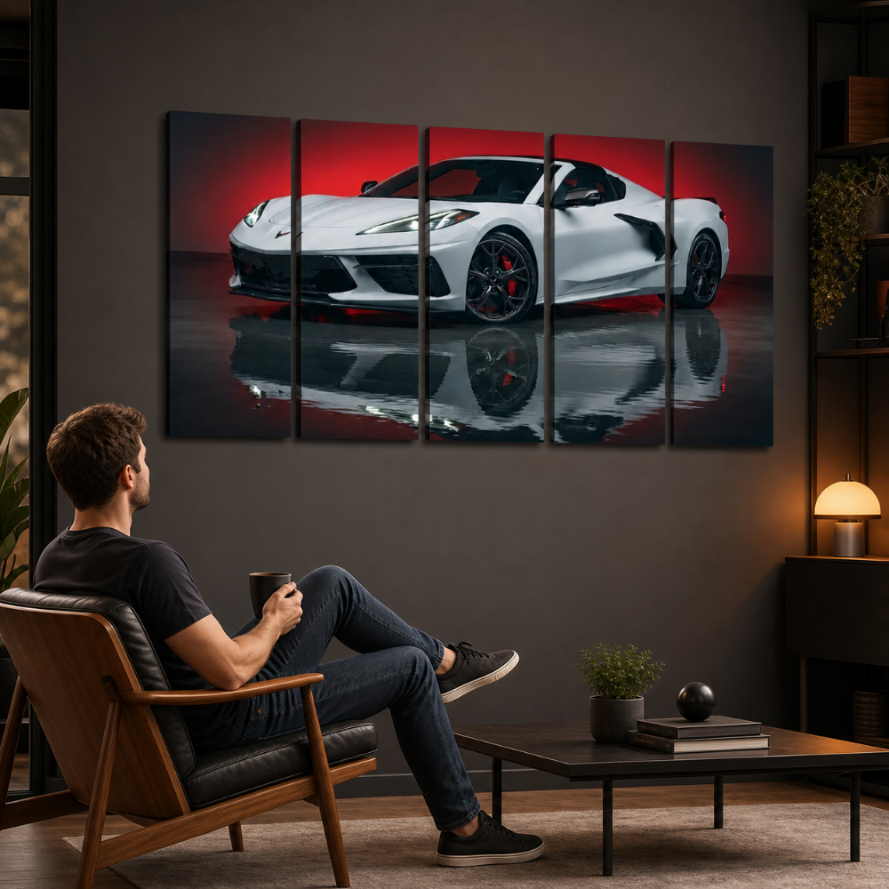 A man relaxes in a wooden armchair in a modern living room, looking at a five-panel canvas wall art print depicting a white sports car on a red reflective studio background.