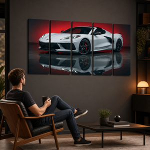 A man relaxes in a wooden armchair in a modern living room, looking at a five-panel canvas wall art print depicting a white sports car on a red reflective studio background.