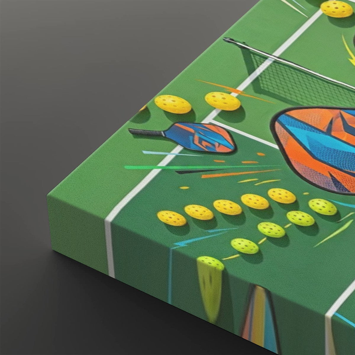 A rectangular canvas print featuring a colorful illustration of a ping-pong table scene, shown at an angle on a dark gray background. The artwork includes a green table surface with white lines, yellow ping-pong balls, blue and orange paddles, and a net.