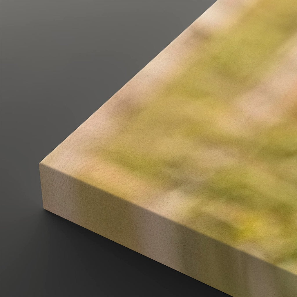 A close-up of a rectangular block or panel corner with a blurred yellow-green and beige surface, photographed against a dark gray background.