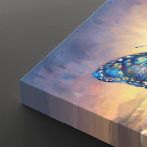 A close-up of a square canvas print showing a painted butterfly wing or insect motif in vivid blue, purple, and gold tones against a soft pastel sky background, photographed on a dark gray surface.