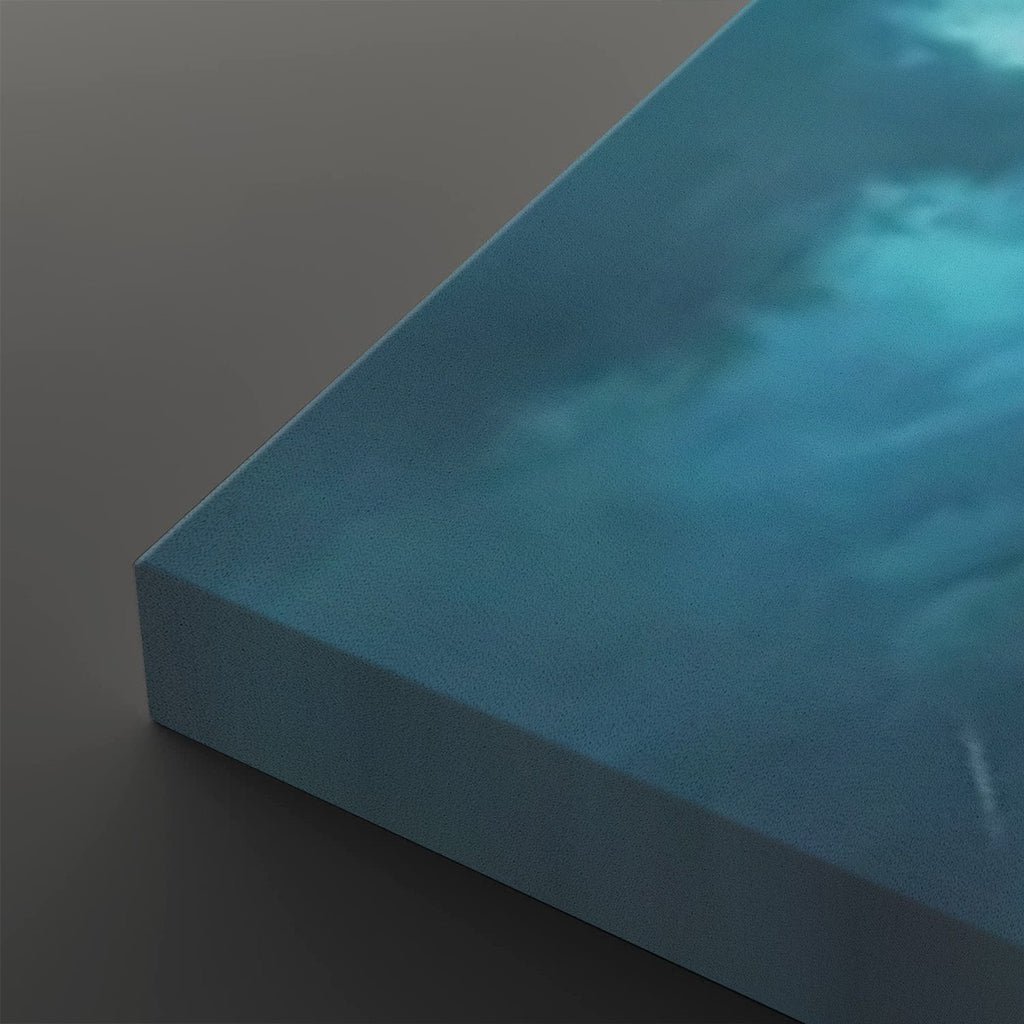 A close-up of a square canvas print showing its wrapped edge and textured surface, featuring a blue and teal cloudy or water-like abstract design on a dark gray background.