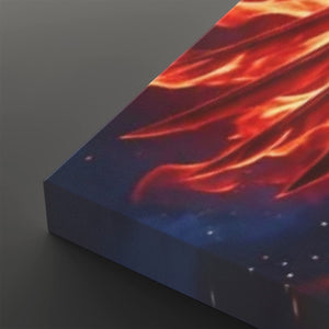 A close-up of a rectangular canvas or panel showing a dramatic fiery scene with bright orange and red flames against a dark blue background with small white specks, photographed on a dark gray surface.