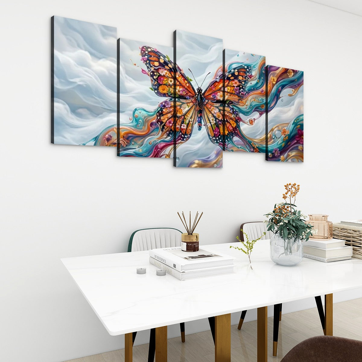 A five-panel canvas wall art set depicting a colorful Monarch butterfly over swirling blue, white, and orange abstract clouds, displayed above a white dining table in a modern room setting.