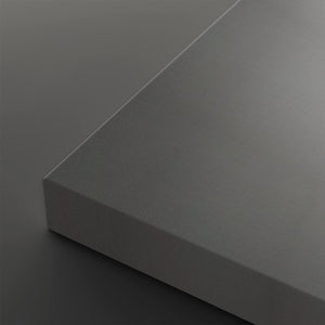 A close-up studio shot of a matte gray rectangular panel or block corner, shown against a matching dark gray background.