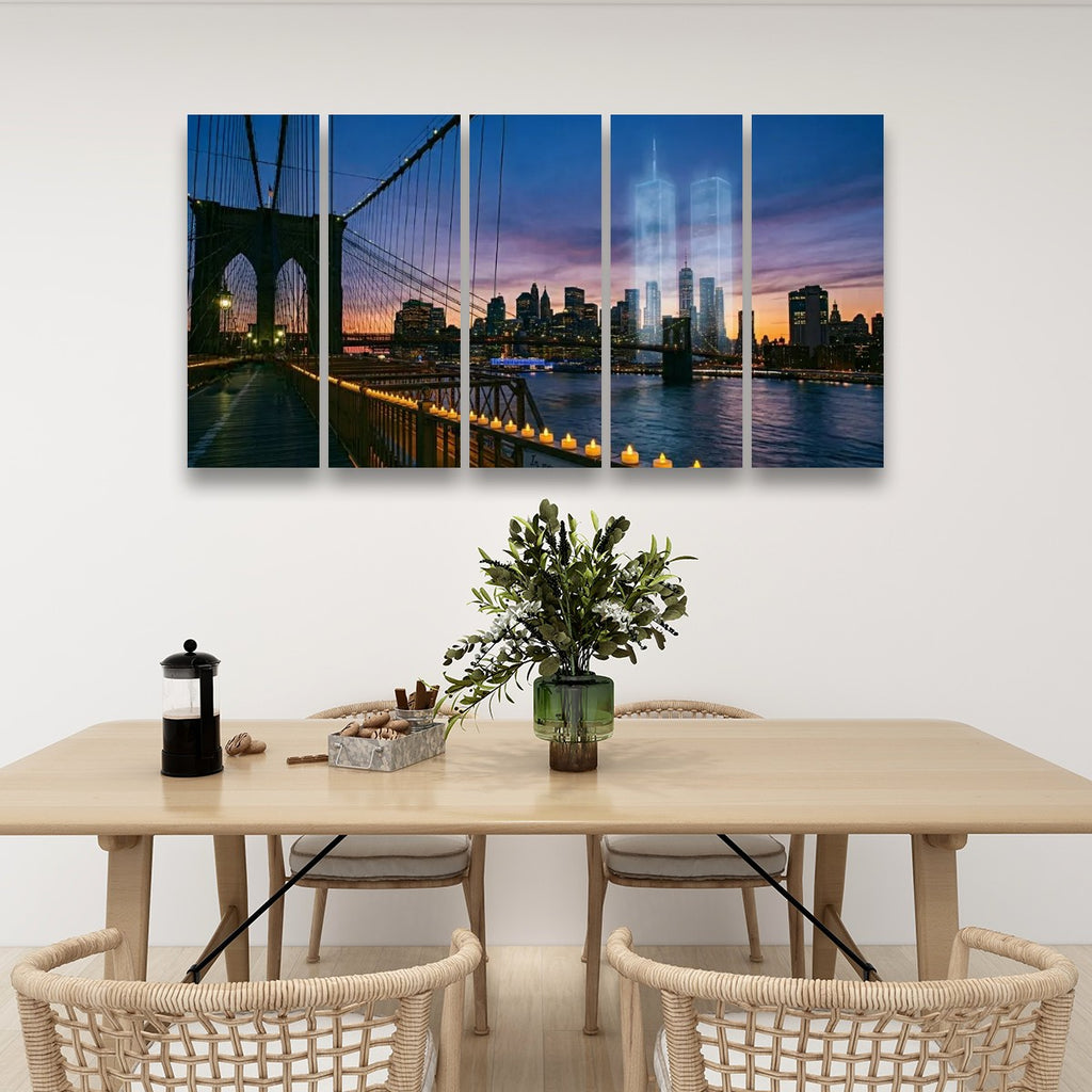 A four-panel canvas wall art set depicting a Brooklyn Bridge and New York City skyline at sunset, displayed on a white wall above a dining table with chairs and a vase.