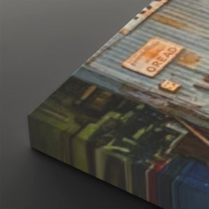 A close-up angled view of a rectangular canvas or print showing an abstract street-art style scene with a corrugated metal surface, a rusted sign reading "OREAD," and blurred vertical shapes below, set against a dark gray background.