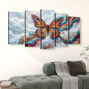 A 4-panel canvas wall art set depicting a colorful Monarch  butterfly over a swirling abstract background, displayed above a green sofa in a living room setting.