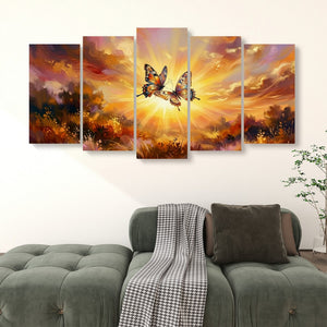 A 5-panel canvas wall art set depicting two butterflies in a glowing sunset landscape, displayed above a green sofa in a living room setting.