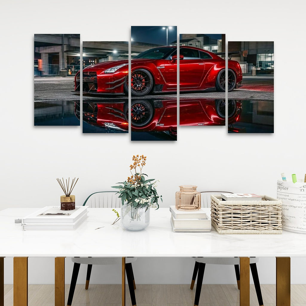 A 5-panel canvas wall art set depicting a red  Nissan GTR R35 sports car reflected in water, displayed on a white wall above a styled dining table with books, a vase, and a basket.