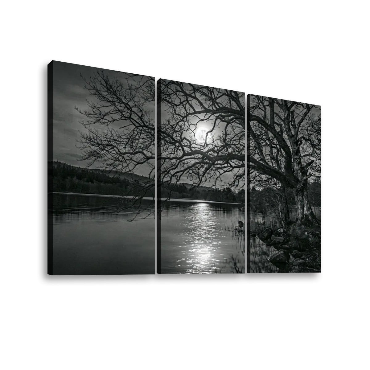 Three-panel black and white canvas wall art showing a lakeside landscape with bare tree branches, dark shoreline, and bright moonlight reflection on the water, displayed against a white background.