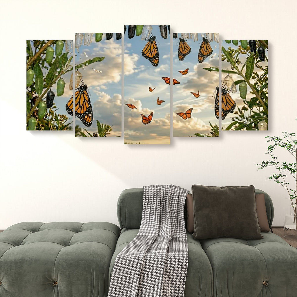 A five-panel canvas wall art set depicting monarch butterflies flying among green leaves and flowers under a cloudy sky, displayed above a green sofa in a living room setting.