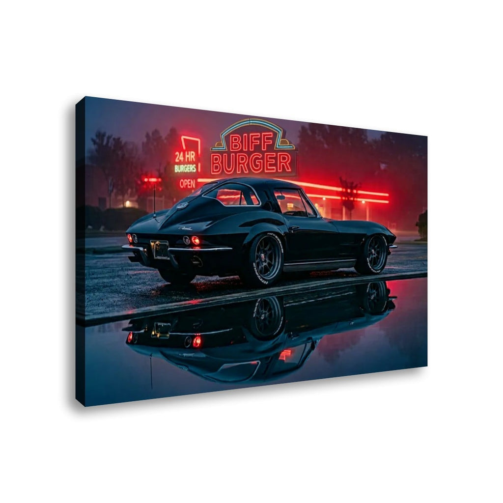A rectangular wall art canvas showing a black classic 1963 Split Window Chevy Corvette parked in front of a glowing red Biff Burger neon sign at dusk, with the car reflected in wet pavement. The canvas is photographed against a plain white background.