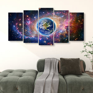 Five-panel canvas wall art depicting a colorful outer space scene with Earth at the center, displayed above a green sofa in a living room setting.