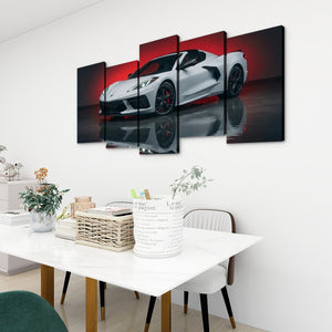 A 5-panel canvas wall art set depicting a white sports car on a reflective dark surface with a red background, displayed on a white wall above a dining table in a modern room setting.