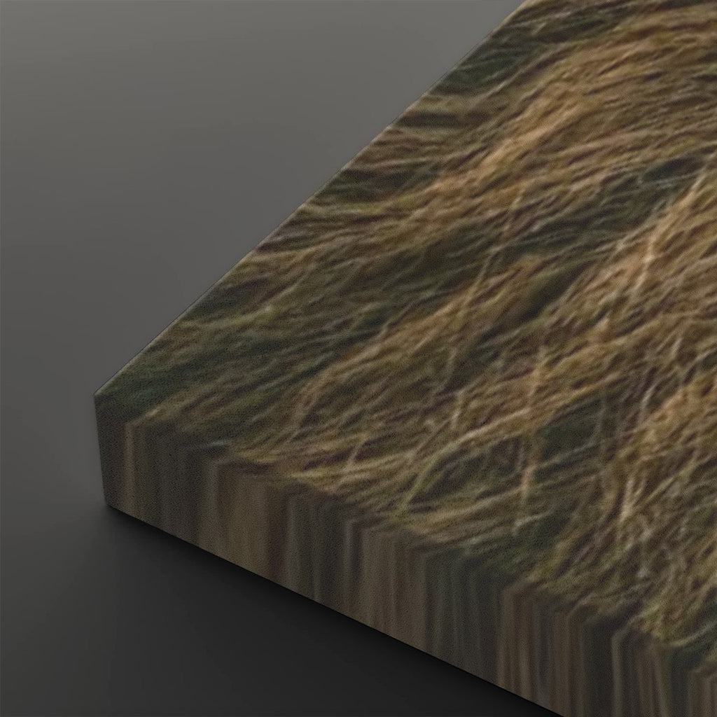 A close-up angled view of a rectangular panel or board with a realistic brown and tan grass-like texture on its top surface, shown against a dark gray background.