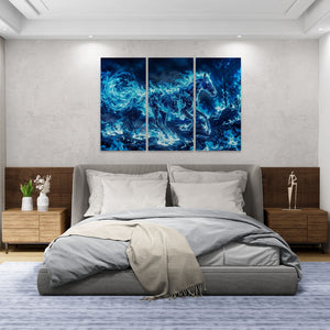 Modern bedroom with a bed and abstract blue artwork on the wall