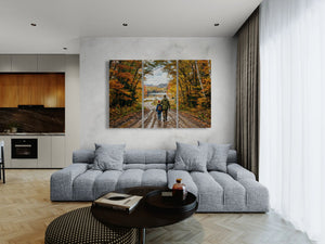 Modern living room with a large sectional sofa, coffee table, and wall art depicting a scenic landscape.