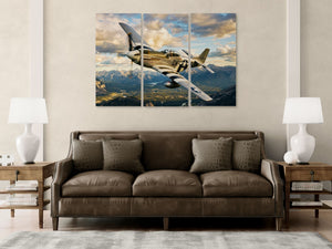 Large wall art of a vintage  P-51 Mustang airplane over mountains above a brown sofa in a living room.