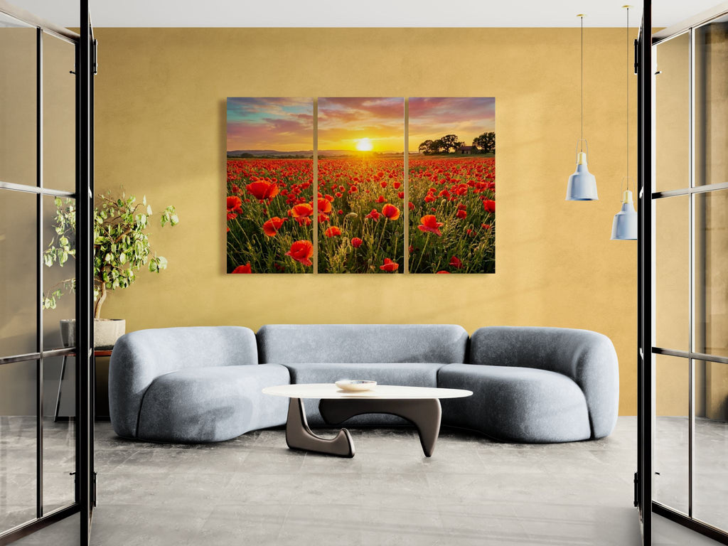 Modern living room with a triptych painting of a sunset over a field of red poppie flowers on a yellow wall.