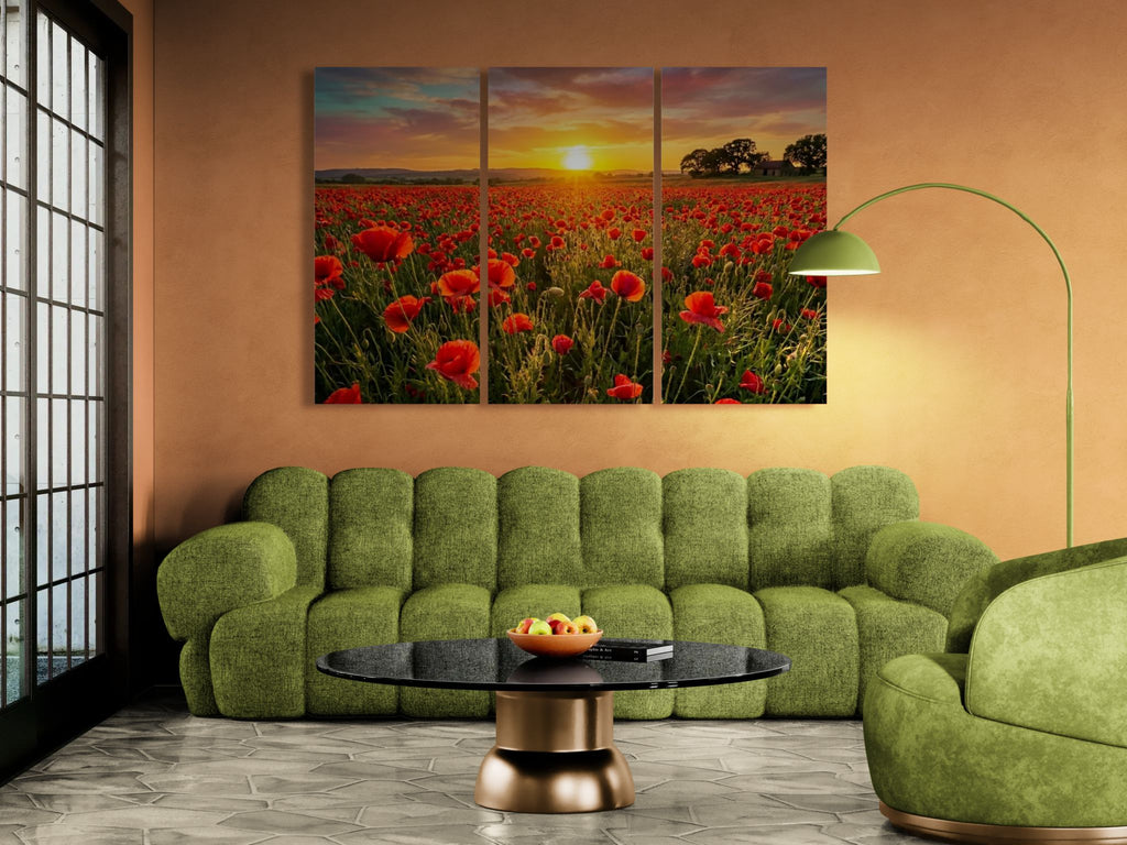 Green sofa in a living room with a large wall art of a sunset over a field of red poppie flowers.