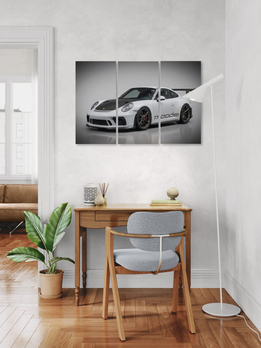 Modern office with a desk, chair, and decorative items, featuring a 911 car poster on the wall.